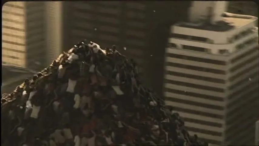 A diverse crowd of people, dressed in casual clothing, struggle to climb a mountain of people in a city, with buildings in the background.