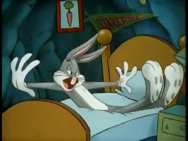 Bugs Bunny, a grey rabbit, jumps on a bed in a dark bedroom, startled awake by an unseen force.