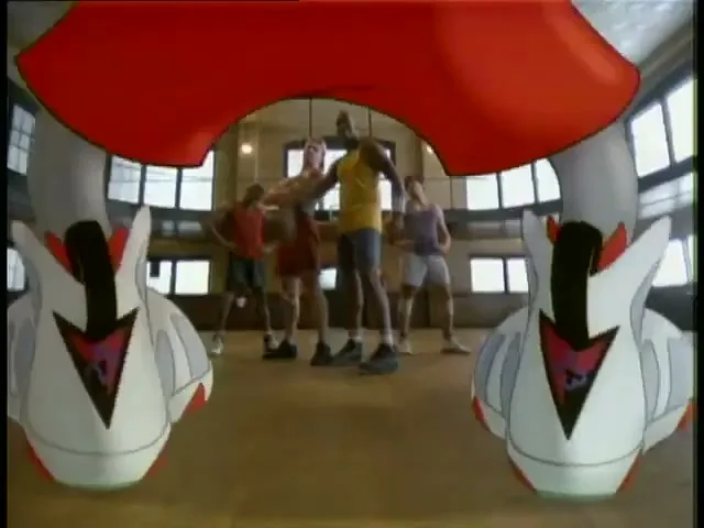 A group of basketball players, including Michael Jordan, stand on a court as animated Bugs Bunny legs and shoes appear in the foreground.