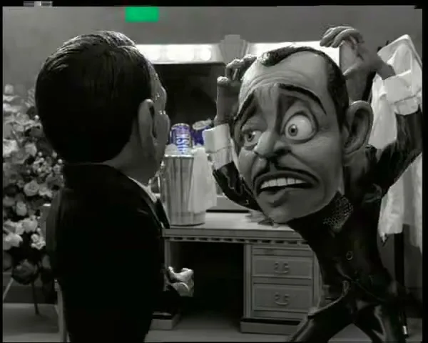 A stop-motion animated puppet resembling Frank Sinatra, with an exaggerated head, is pulled back by another puppet in a dressing room.