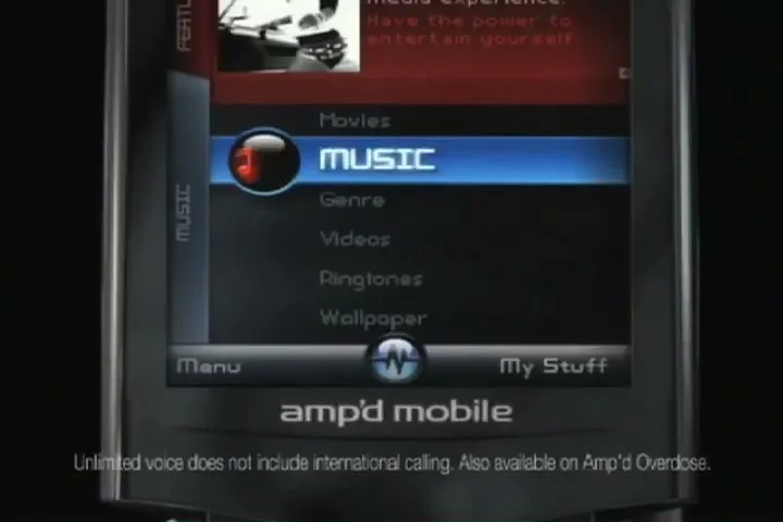 A close-up shot of an Amp'd Mobile phone screen, showing the user interface with "MUSIC" highlighted, against a dark background.