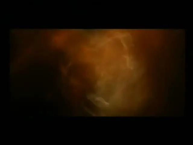 A small, glowing, orange and yellow nebula-like cloud expands and fills the screen against a black background.