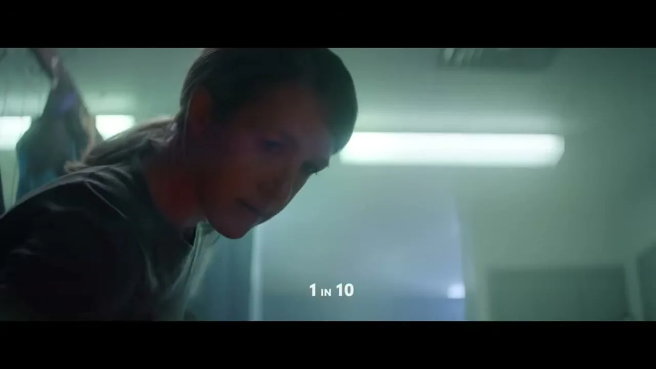 A young female athlete with a ponytail looks down, then up, in a locker room, with text "1 IN 70" changing to "1 IN 10".