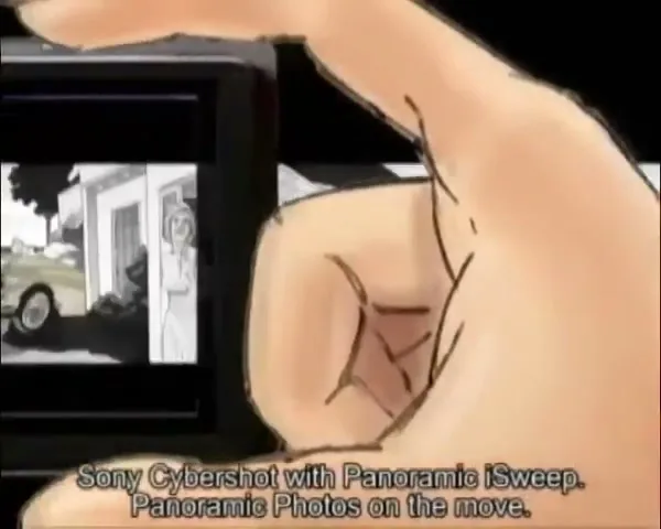A hand holds a Sony Cybershot camera, displaying a panoramic image of a woman standing outside a house with a car in the driveway, as the camera pans across the scene.