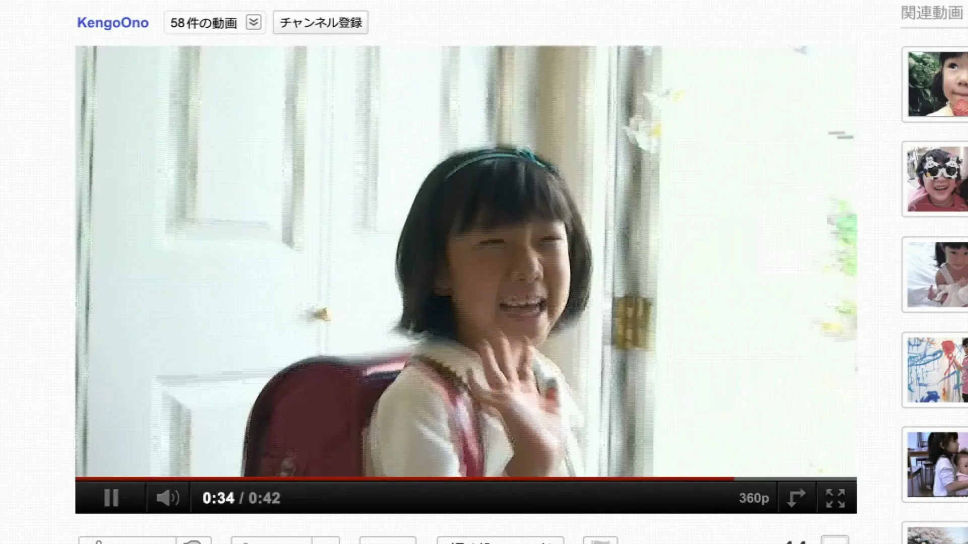 A young Japanese girl with a red backpack waves goodbye as she leaves her home, captured in a YouTube video player.