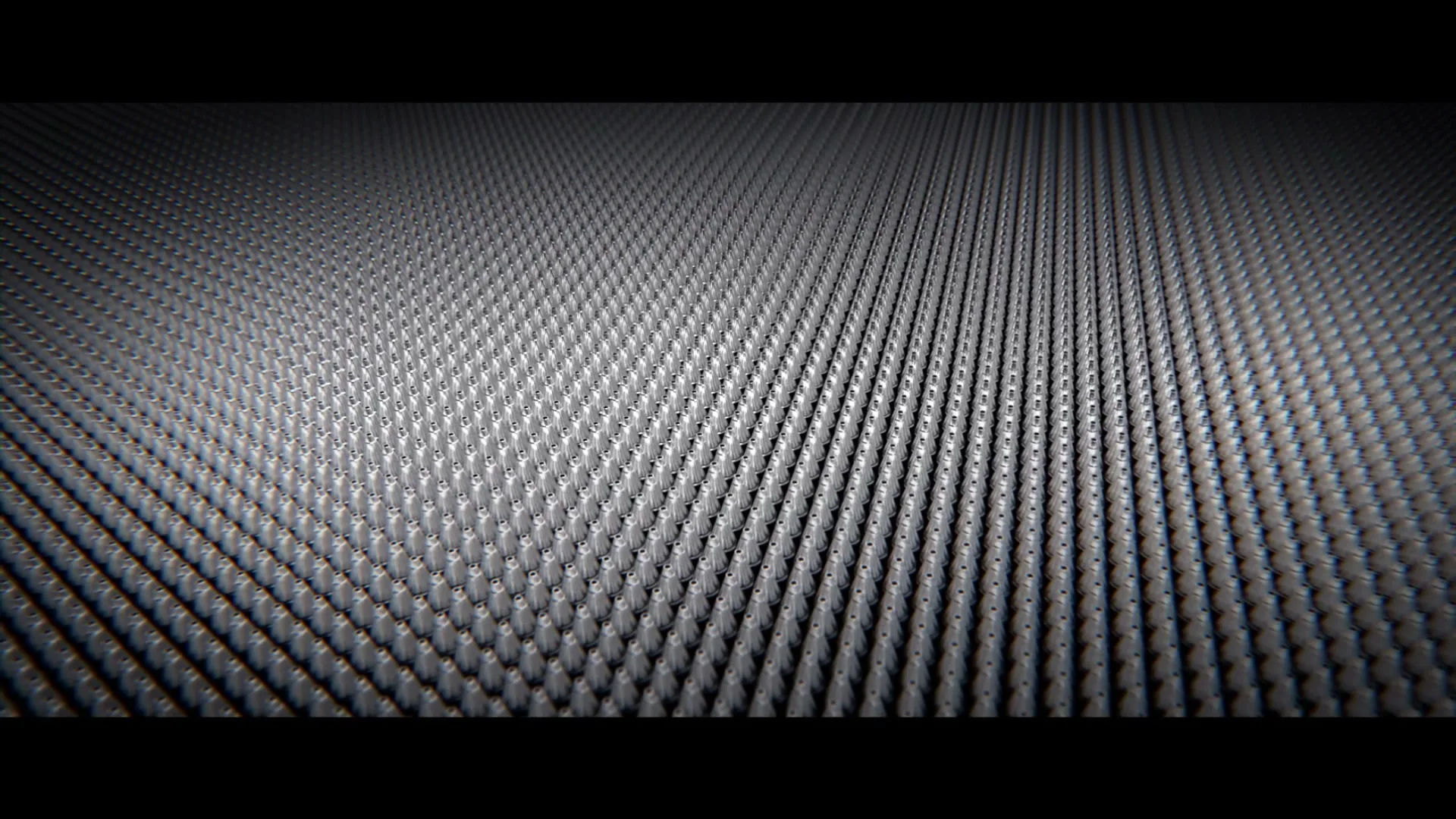 A grid of small, dark, pen-like objects on a dark surface shifts and forms the shape of a pen.
