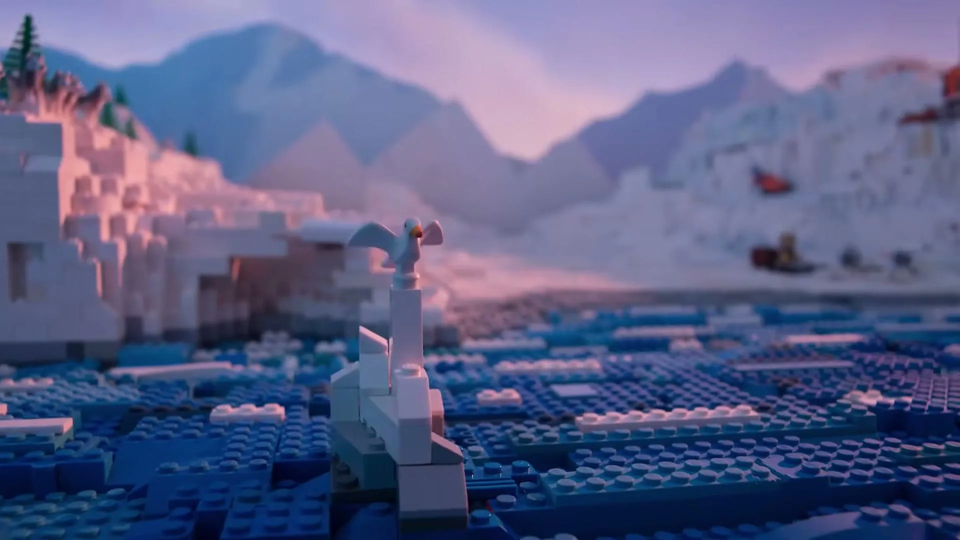 A Lego seagull stands on a small iceberg in a vast Lego ocean, with Lego icebergs and mountains in the background under a pink sky.