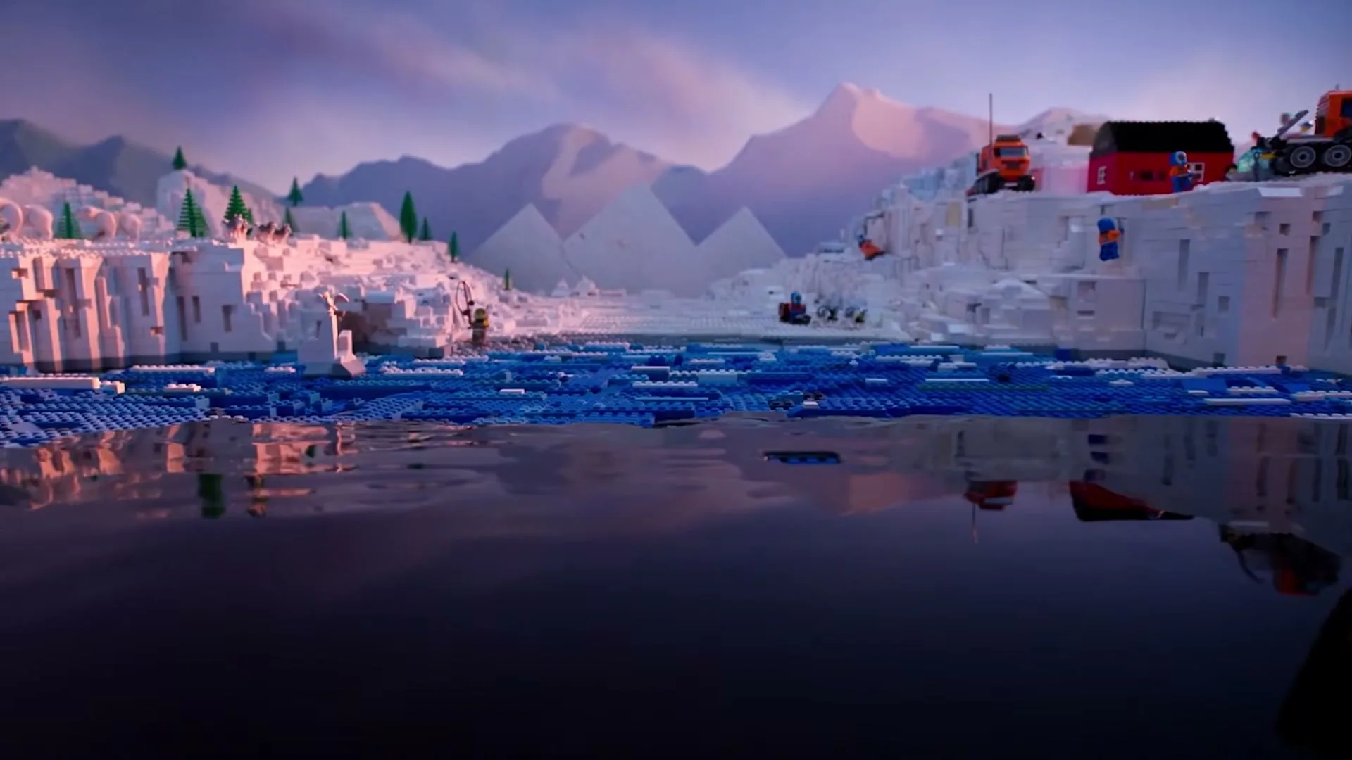 A wide shot of a Lego-built Arctic landscape with icebergs, mountains, and a dark blue ocean, featuring Lego figures and vehicles.