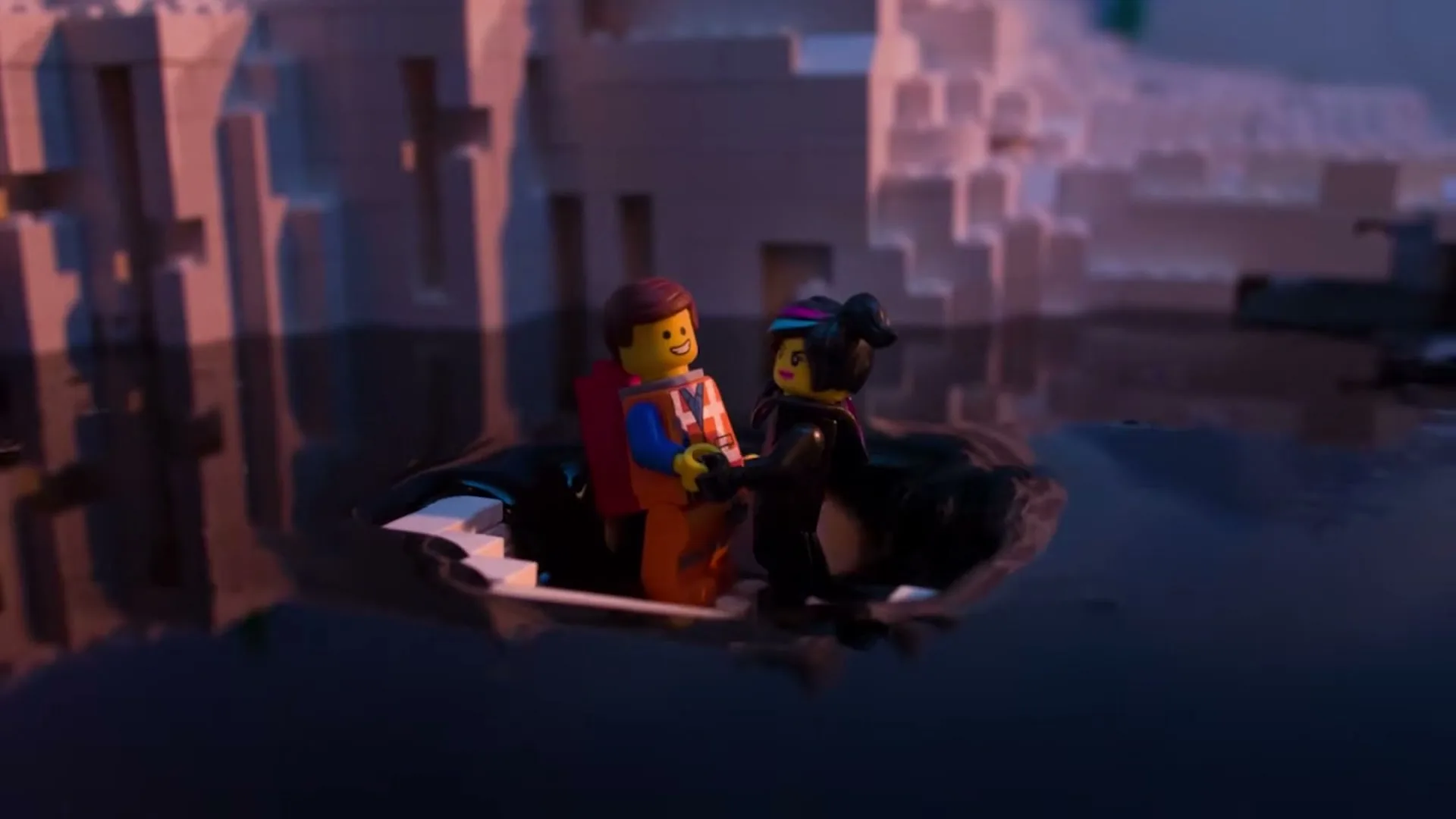 Two Lego figures, Emmet and Wyldstyle, hold hands in a small boat made of Lego bricks, floating on dark water with Lego icebergs in the background.