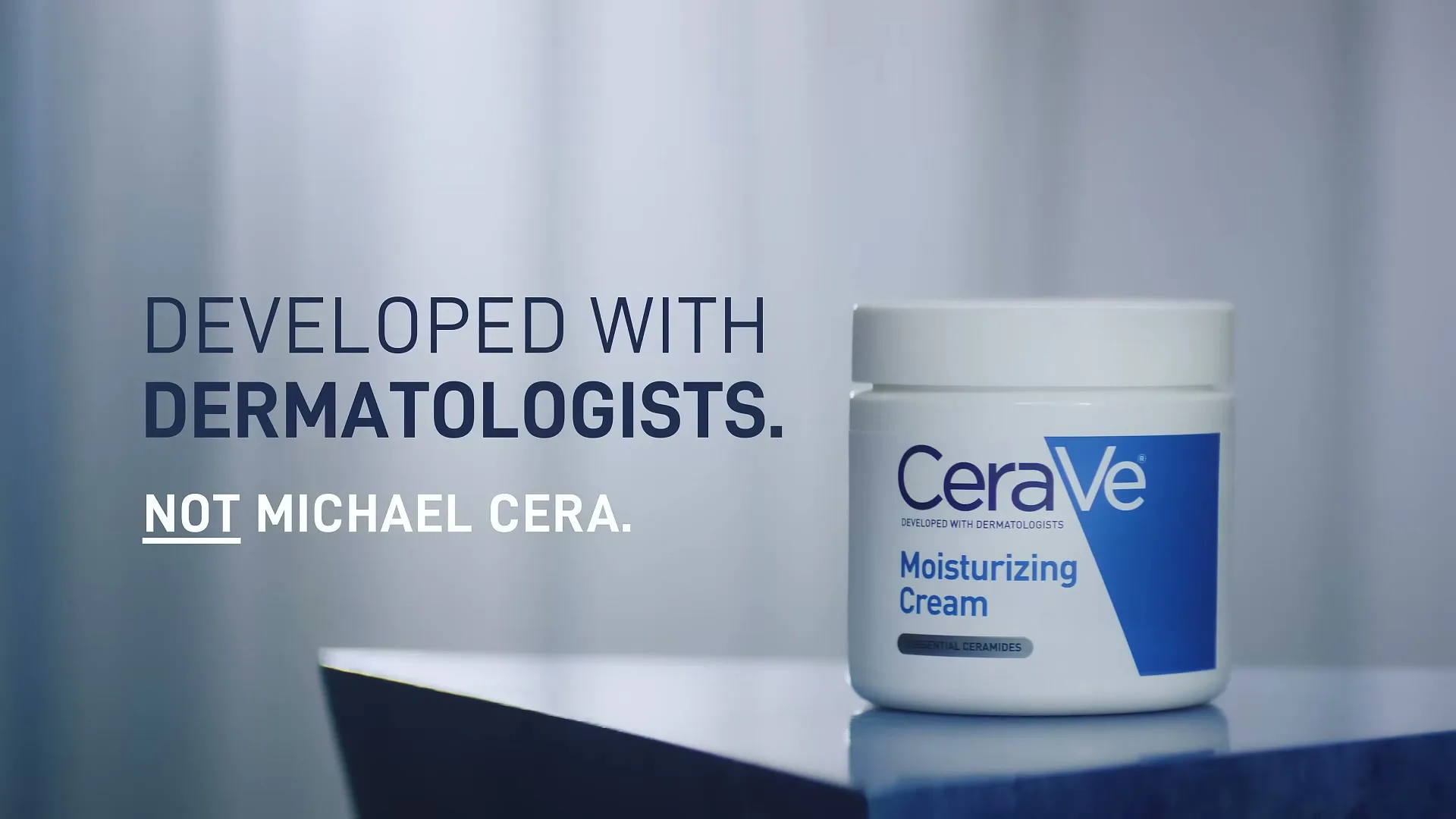 A white jar of CeraVe Moisturizing Cream sits on a blue and white surface, with text "DEVELOPED WITH DERMATOLOGISTS. NOT MICHAEL CERA." on the left.