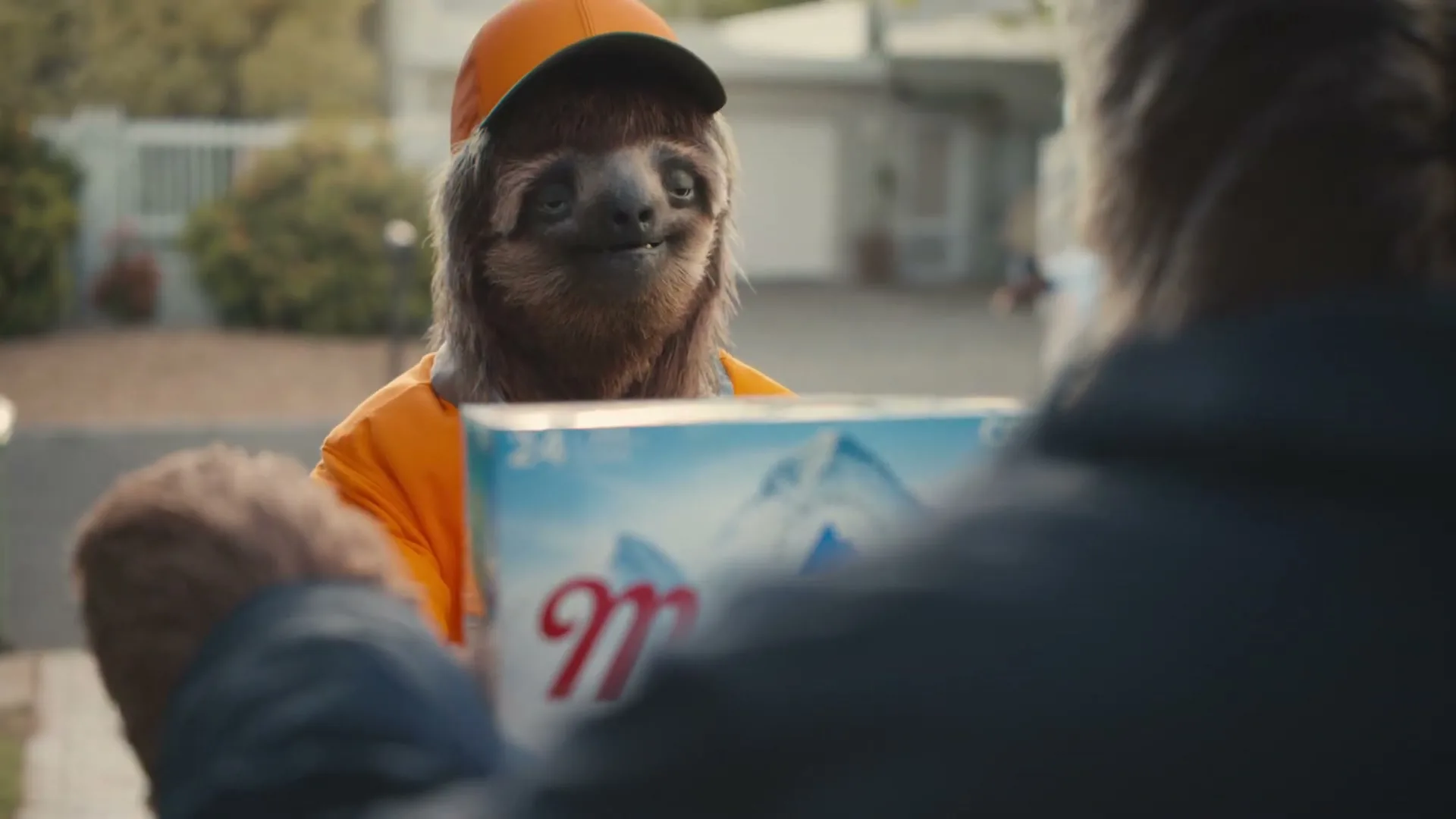 A sloth-like delivery person in an orange uniform and cap hands over a case of Coors Light to a customer in a suburban setting.
