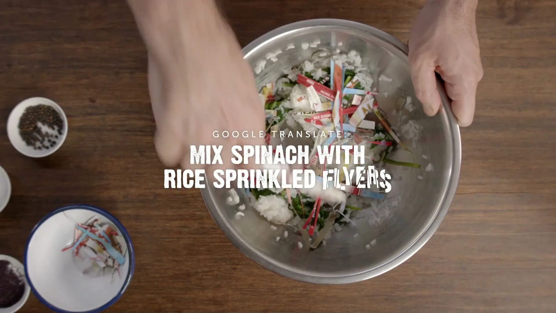 A man's hands mix spinach, rice, and colorful paper flyers in a metal bowl on a wooden table, with text overlaying the scene.