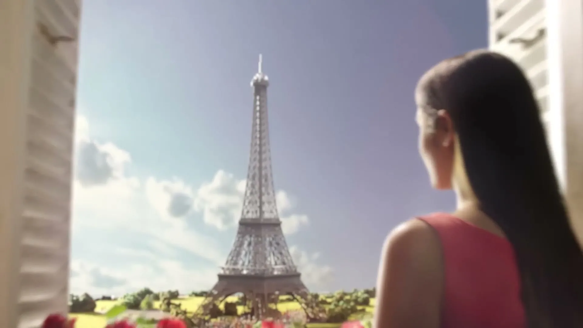 A woman in a red dress looks out a window at the Eiffel Tower in Paris, with red flowers on the windowsill.