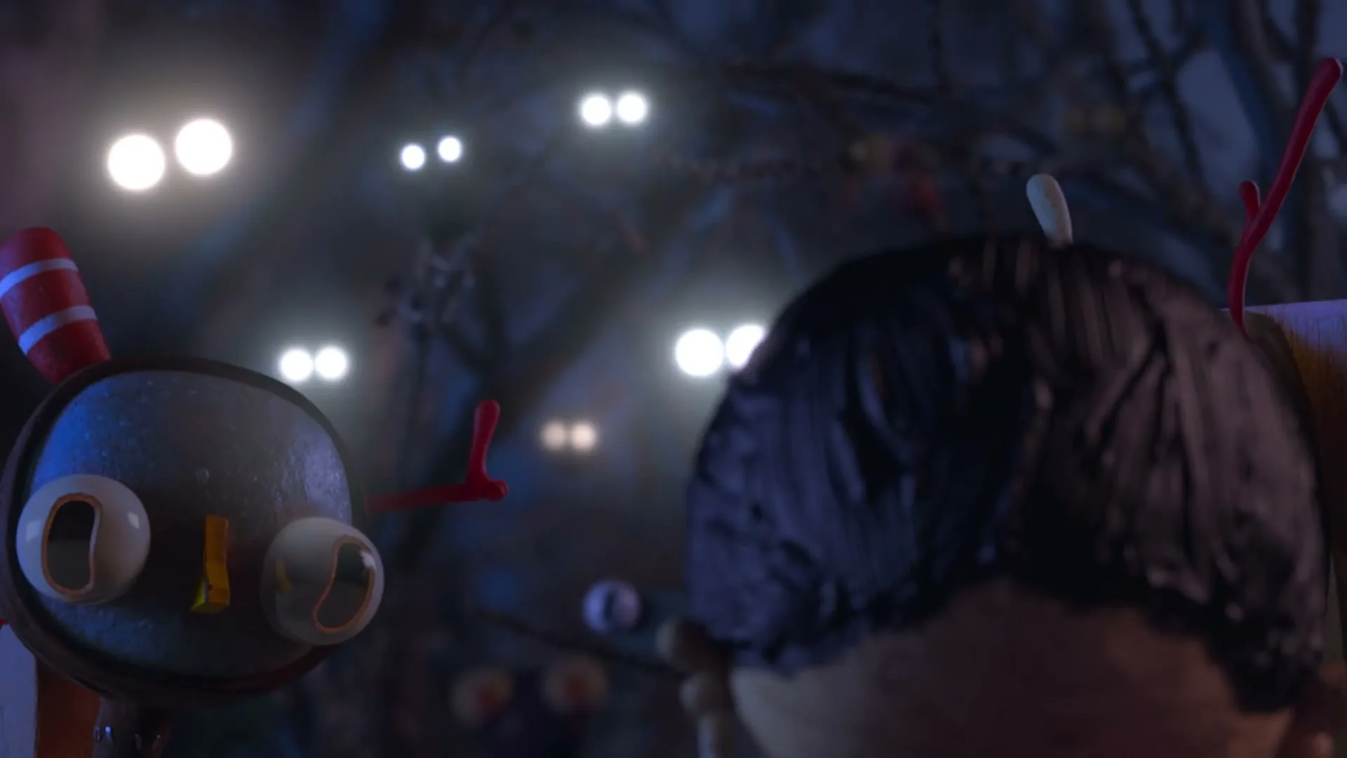 A stop-motion animated boy with dark hair looks at a creature with glowing eyes, surrounded by many other glowing eyes in a dark, mysterious forest.