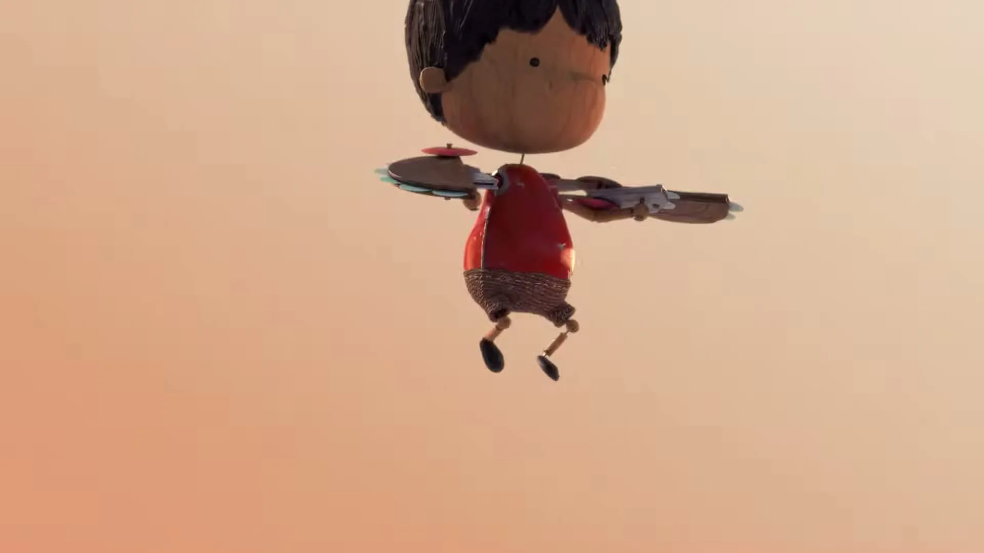 A stop-motion animated boy with dark hair and a red shirt floats against an orange background, with text appearing on screen.