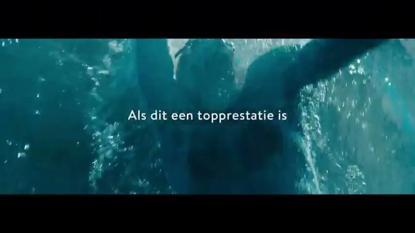 A swimmer with a disability is seen from above, swimming in a pool, with text overlaid on the screen.