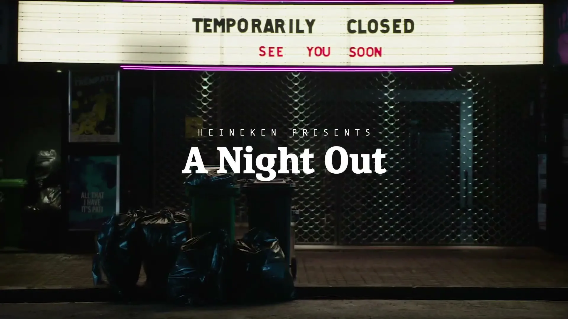 A yellow taxi drives past a closed bar or club with a marquee sign that reads "TEMPORARILY CLOSED SEE YOU SOON" at night.