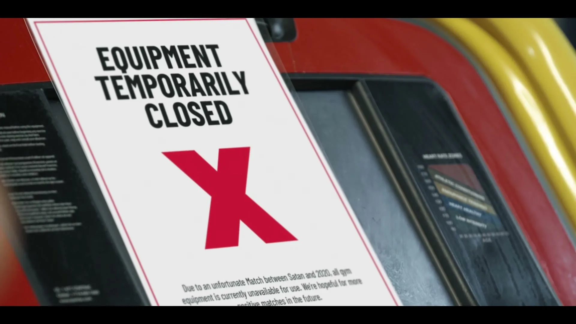 A close-up shot of a sign on gym equipment that reads "EQUIPMENT TEMPORARILY CLOSED" with a large red X, and a disclaimer below.