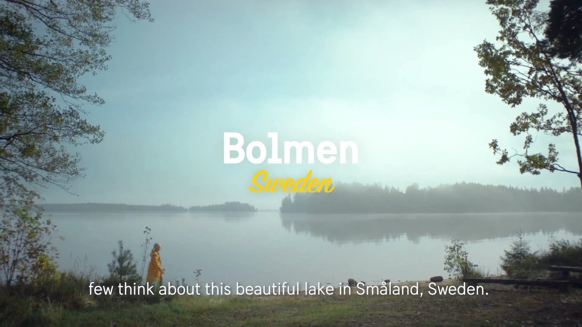 A person in a yellow raincoat stands by a misty lake, raising their arm, with text overlaying the scene.