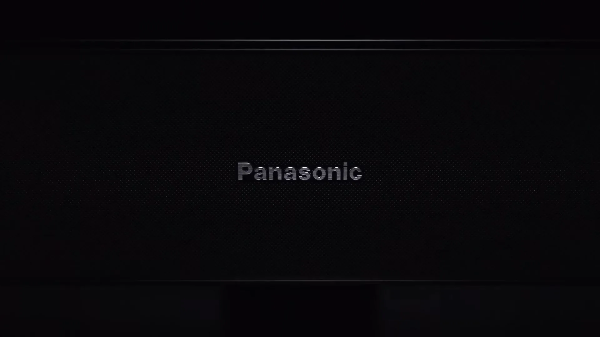 The Panasonic logo, in a metallic silver, is centered on a dark, textured background, then quickly slides off-screen to the left.