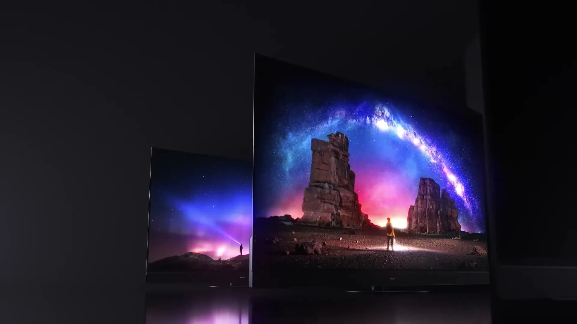 A series of Panasonic TVs display vibrant, colorful landscapes with aurora borealis and starry skies, showcasing their picture quality in a dark studio.