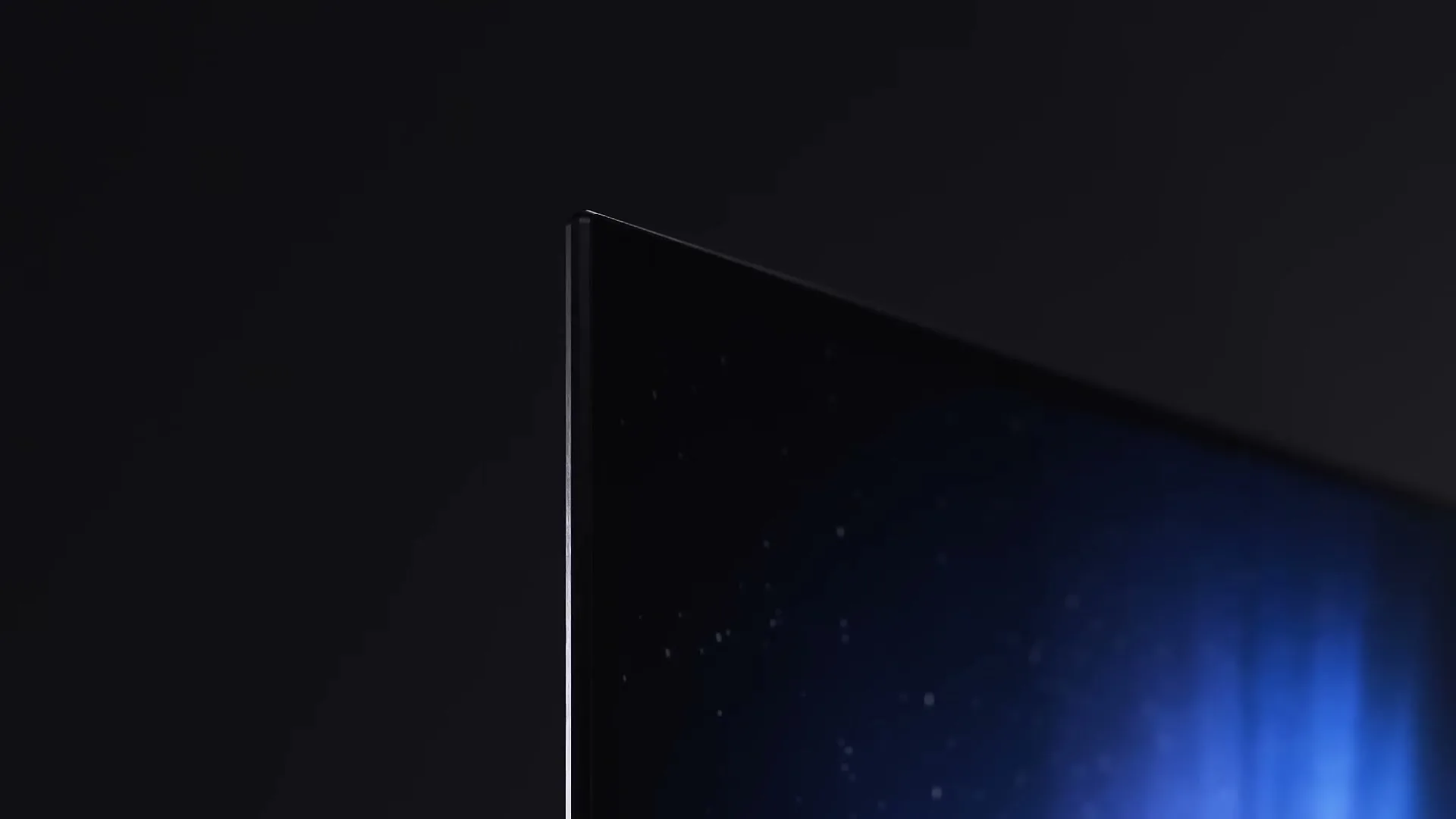 A close-up shot of a sleek, thin television screen displaying a dark image with subtle blue light, set against a dark background.