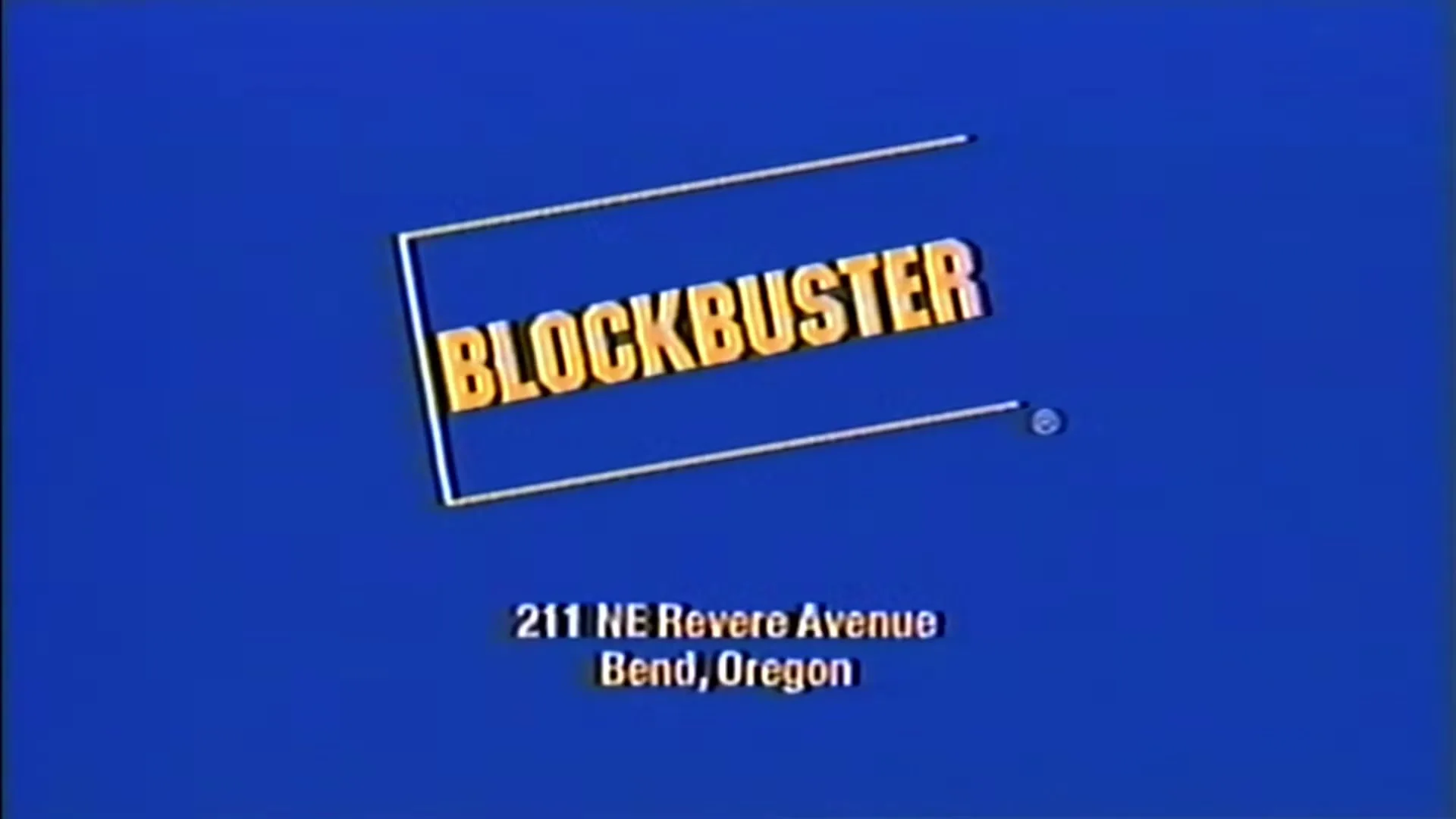 The Blockbuster logo and address appear on a blue screen with a retro VHS effect, concluding the commercial.