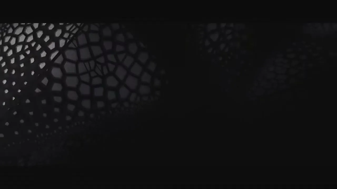 A dark, abstract background with a geometric, honeycomb-like pattern slowly emerges from the left side of the frame.