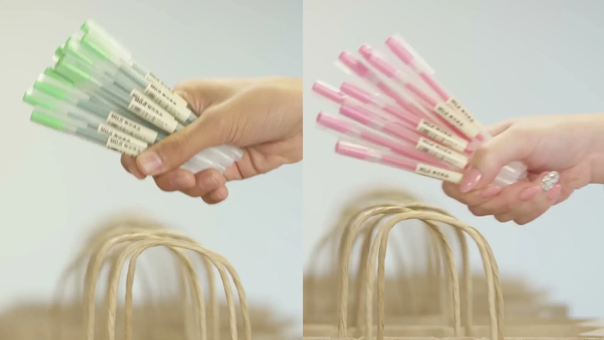 Two hands, one with green pens and one with pink pens, hover over brown paper bags in a bright, clean setting.