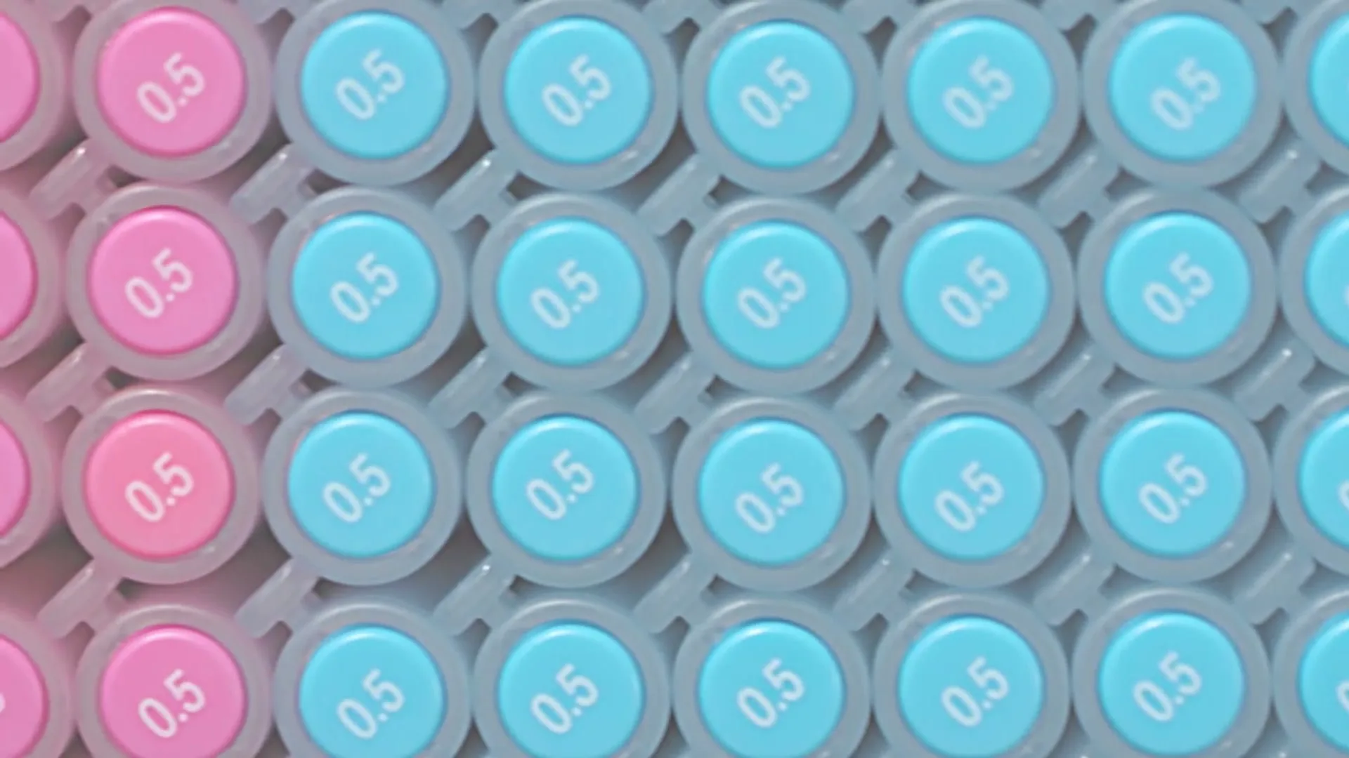 A close-up shot shows a grid of light blue and pink pen caps, each marked with "0.5", as they shift from right to left.