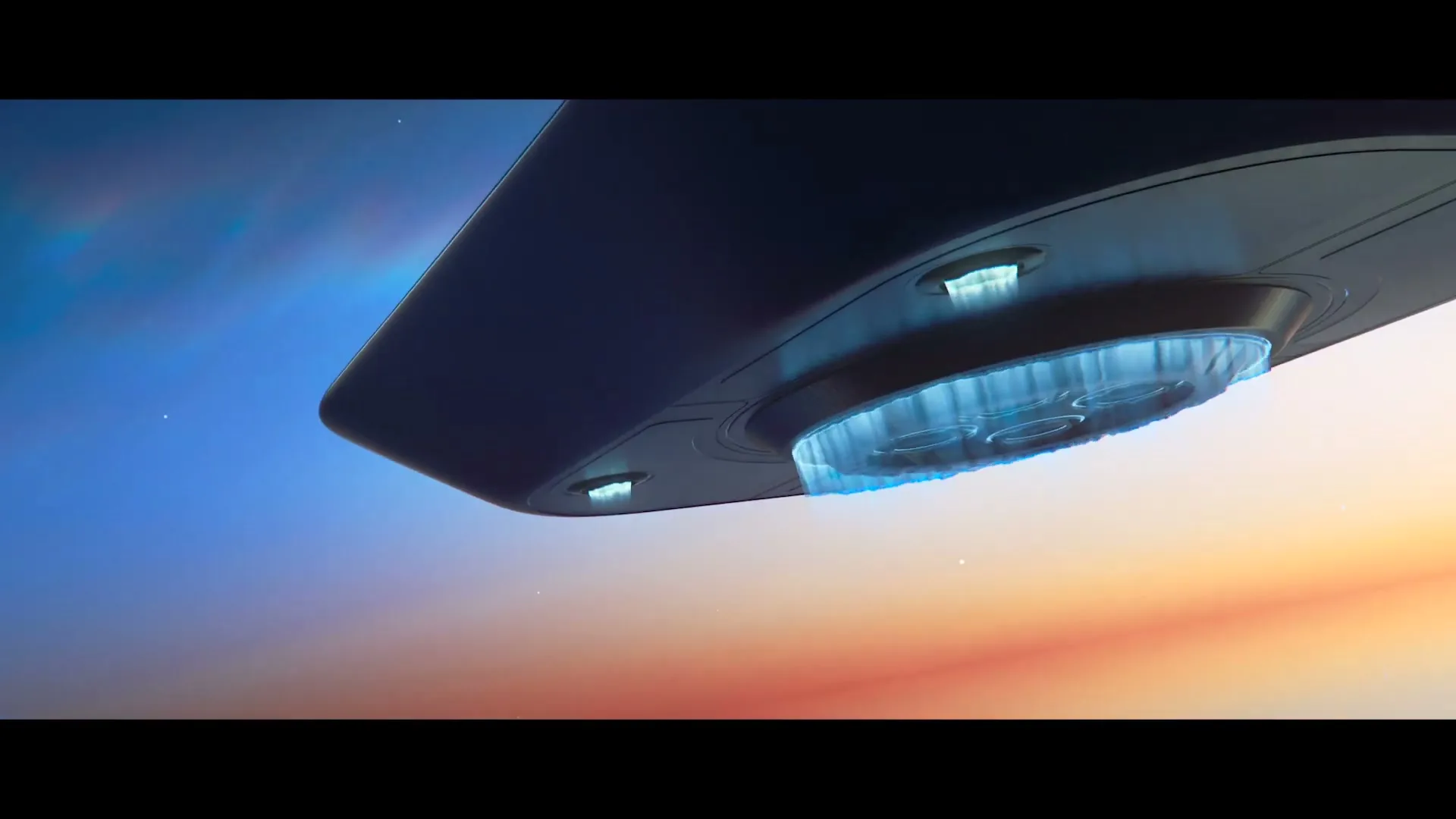 A dark, sleek, futuristic spacecraft with glowing blue lights hovers in the sky during a colorful sunset.