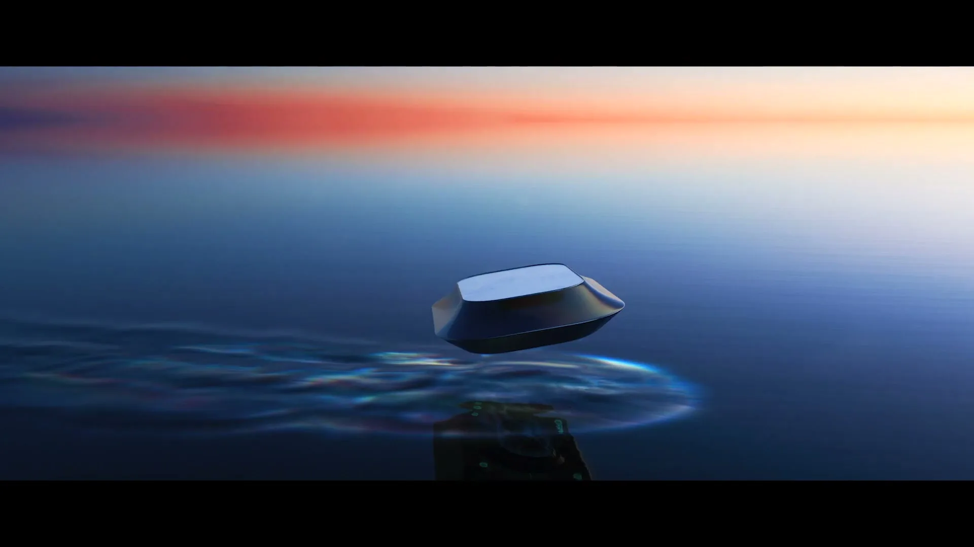 A dark, geometric object hovers above a calm body of water, creating ripples and reflections, with a colorful sky in the background.