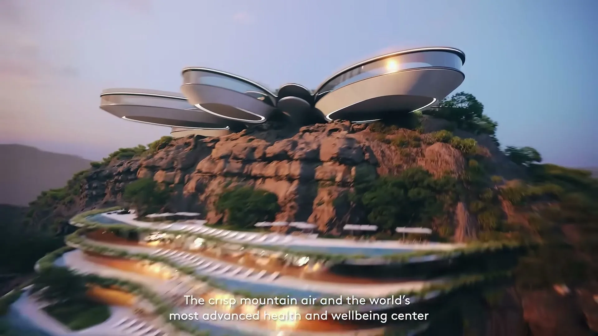 An aerial shot of a futuristic, multi-level building integrated into a rocky mountain landscape at dusk, with text overlay.