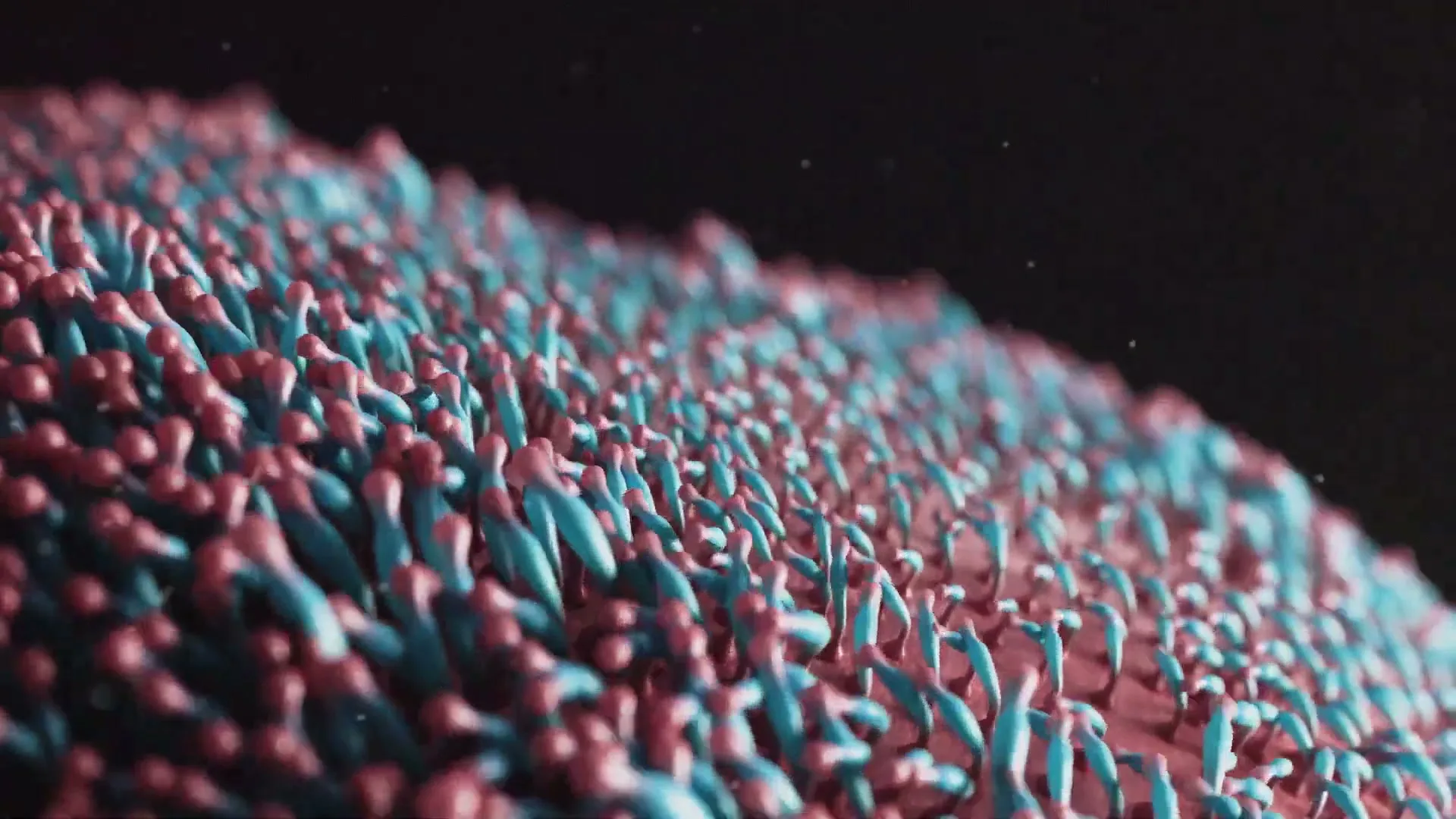 A macro shot of a textured surface with blue and red protrusions, resembling microscopic organisms or a fantastical landscape, against a dark background.
