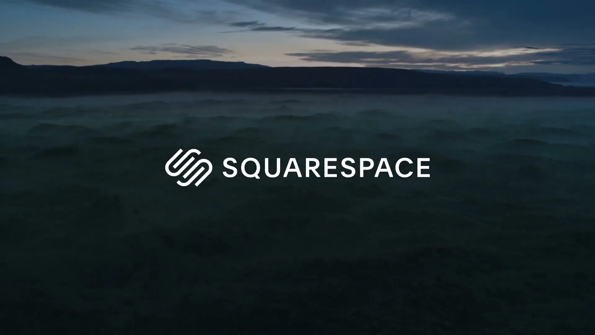 The Squarespace logo and wordmark are centered on screen, with a dark, misty landscape of mountains and fog in the background.