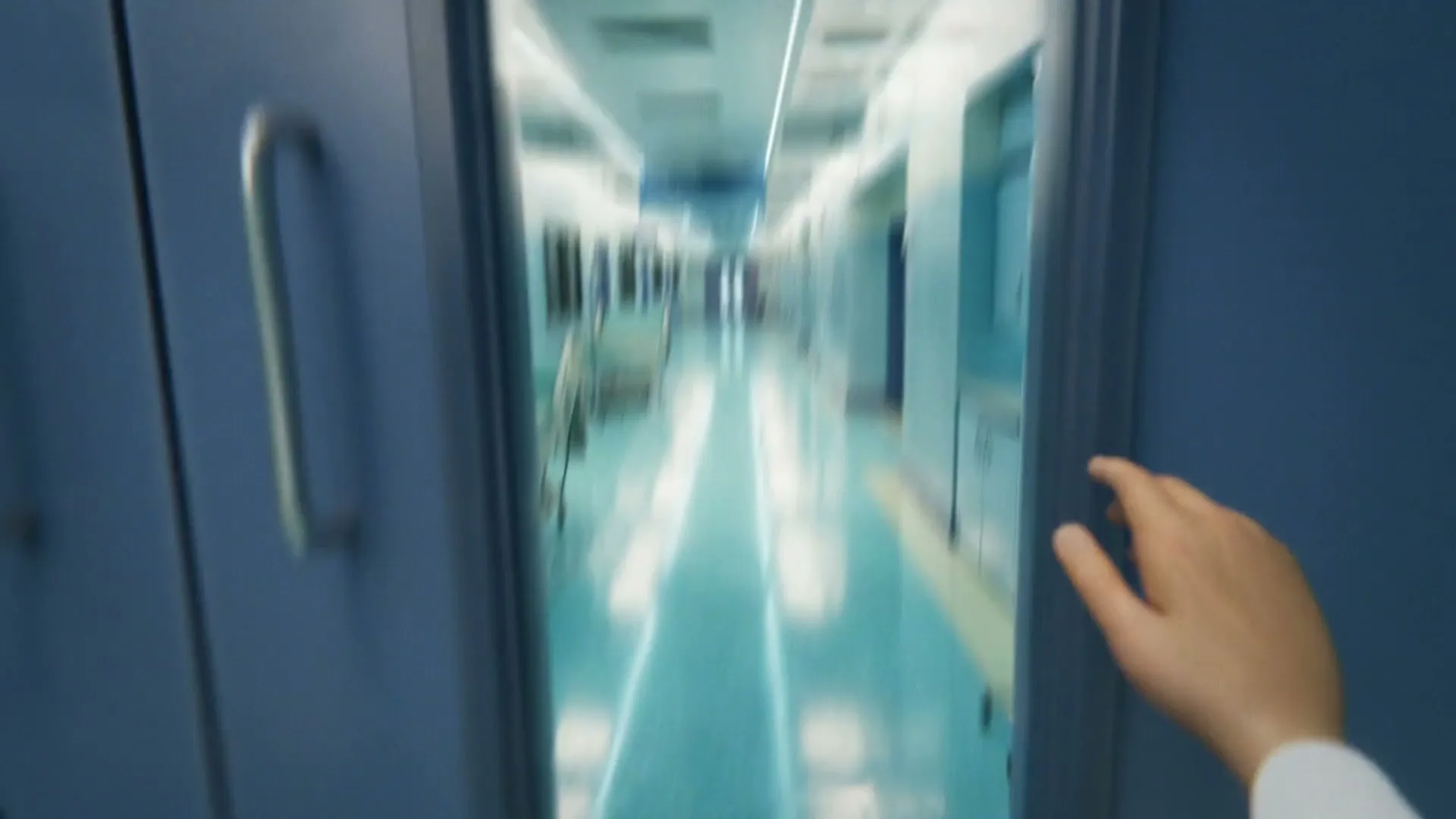 A person's hand holds a smartphone with a text message on the screen, then opens a door to reveal a hospital hallway.