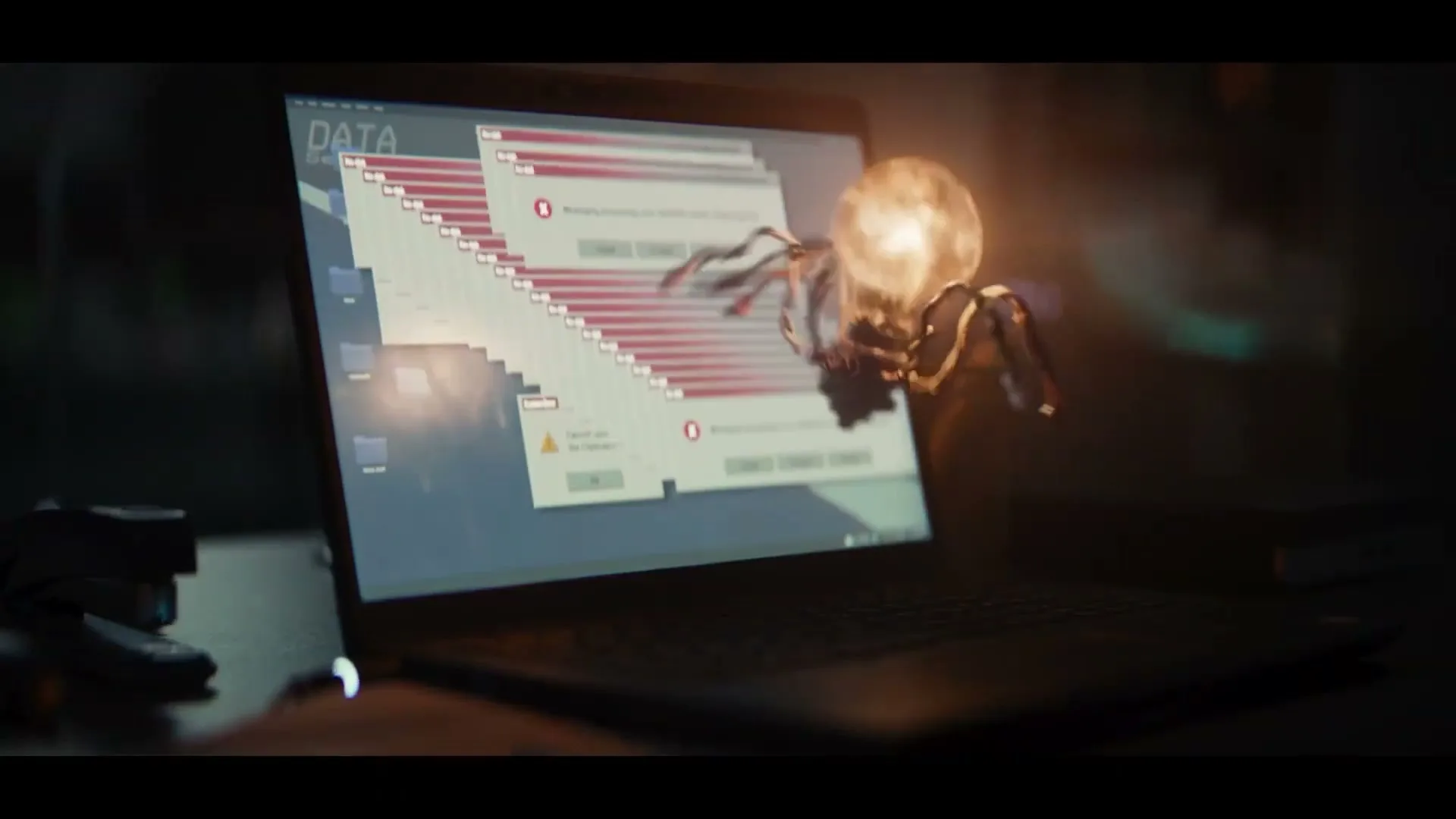 A glowing lightbulb with spider-like legs crawls across a laptop keyboard, while the screen displays multiple error messages and a "DATA" folder.