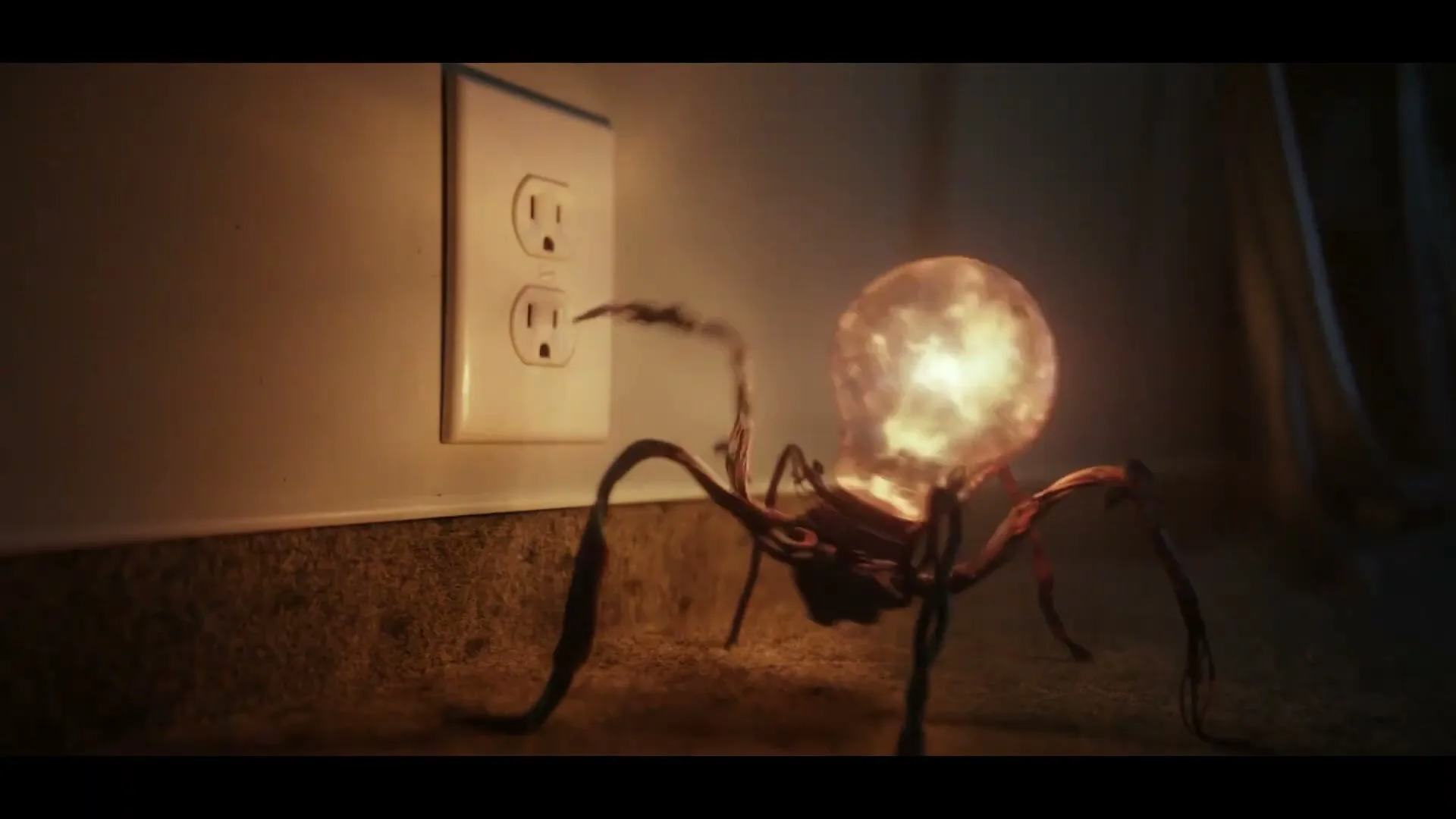 A spider-like creature with a glowing lightbulb for a head approaches a wall outlet, then quickly retracts as sparks fly.