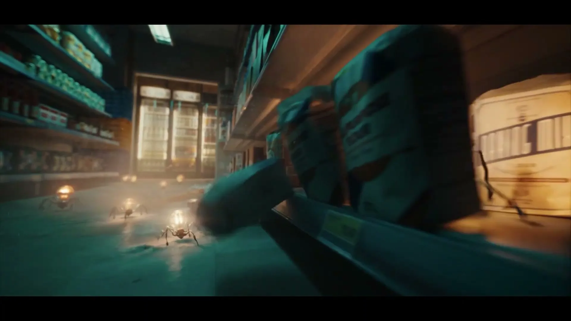 A low-angle shot shows several spider-like creatures with glowing lightbulb bodies scurrying across a dusty supermarket floor, past shelves of products.