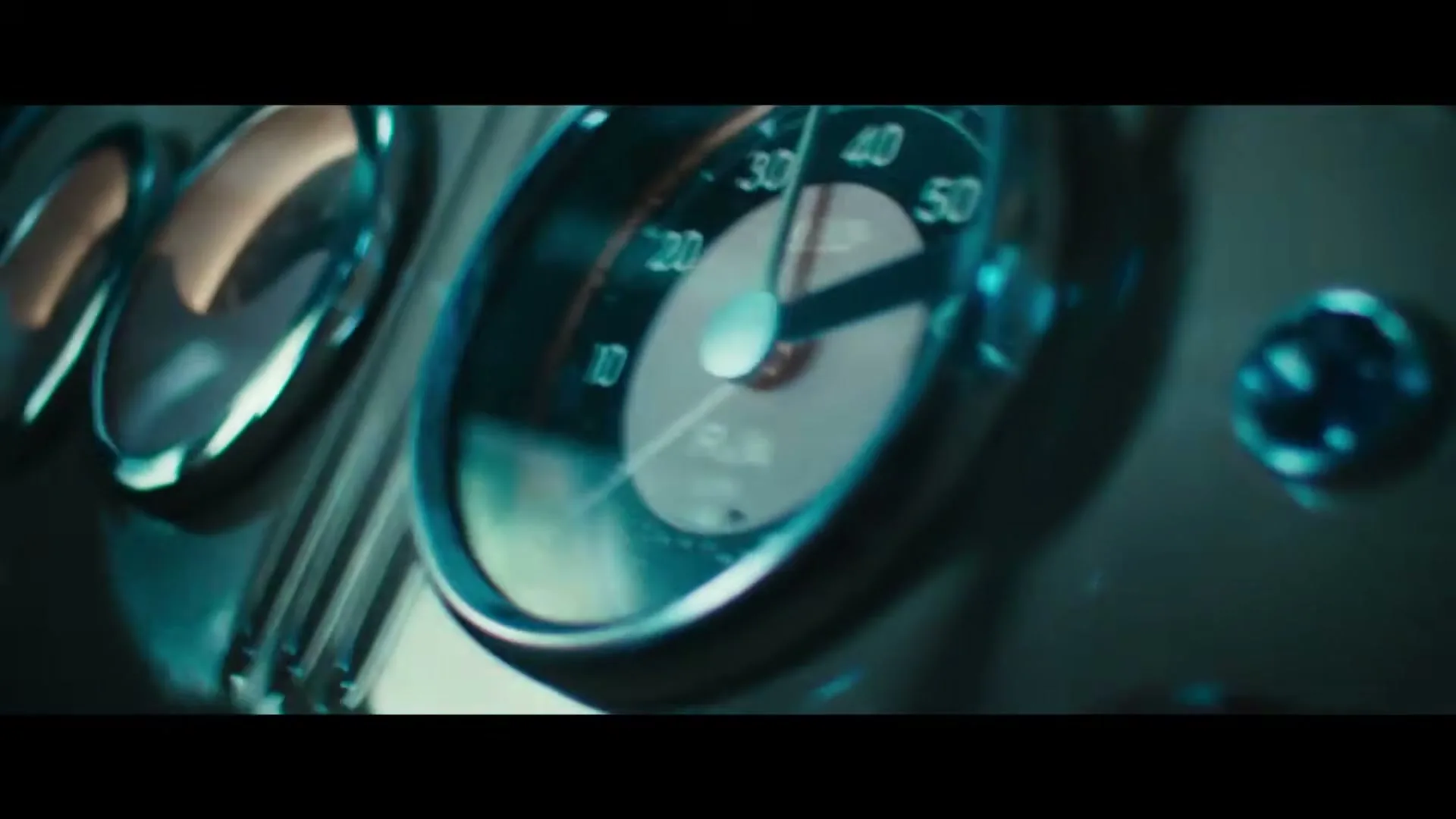 A close-up shot of a vintage car's dashboard, showing the speedometer needle rapidly increasing, highlighting the vehicle's speed and performance.