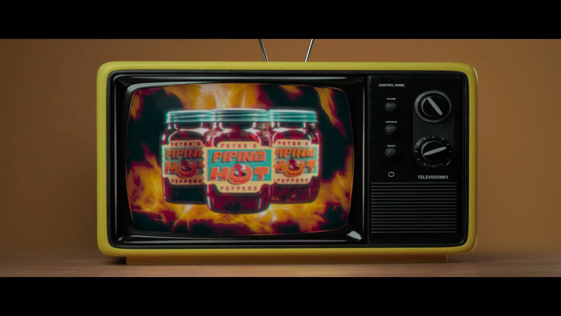 Three jars of "Peter's Piping Hot Peppers" appear on a vintage television screen, surrounded by flames.