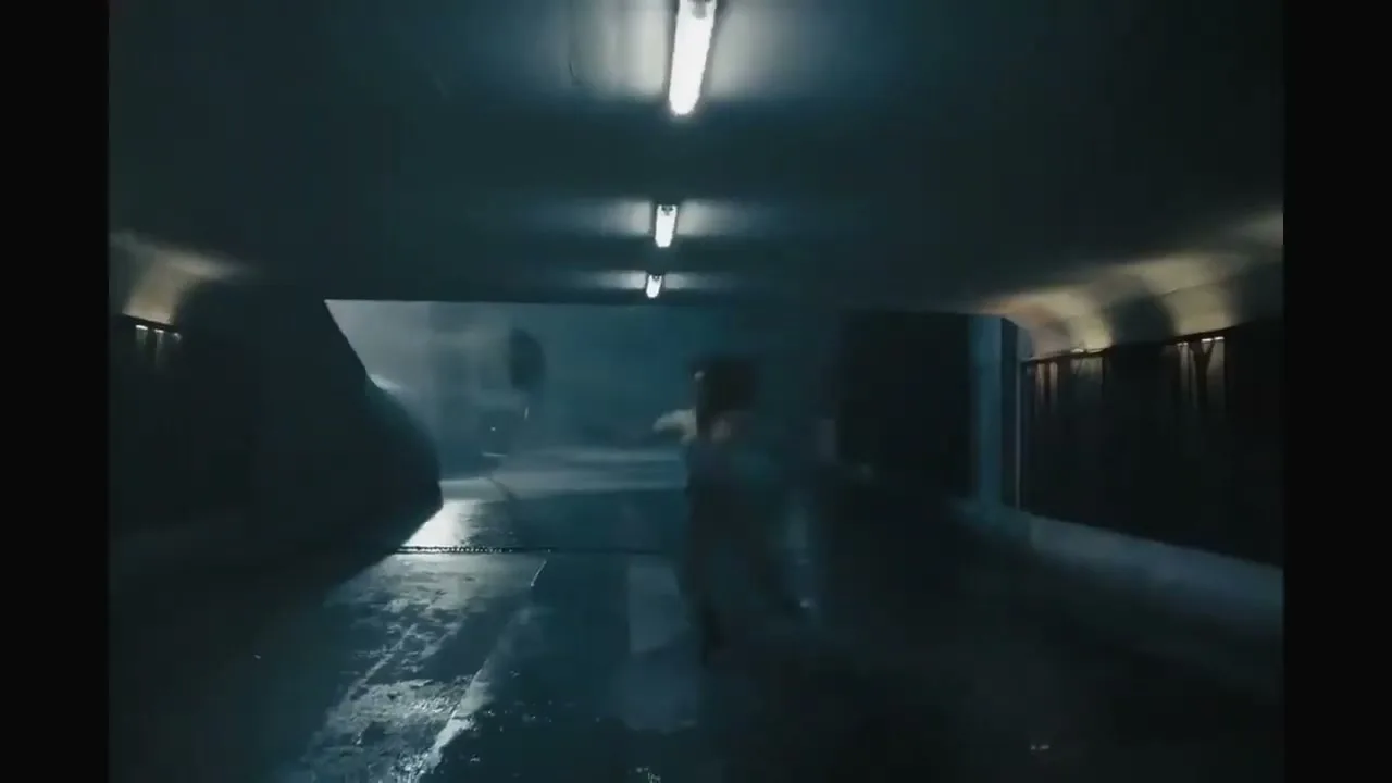 A female dancer in a white leotard leaps gracefully through a dark, wet tunnel, illuminated by overhead fluorescent lights.