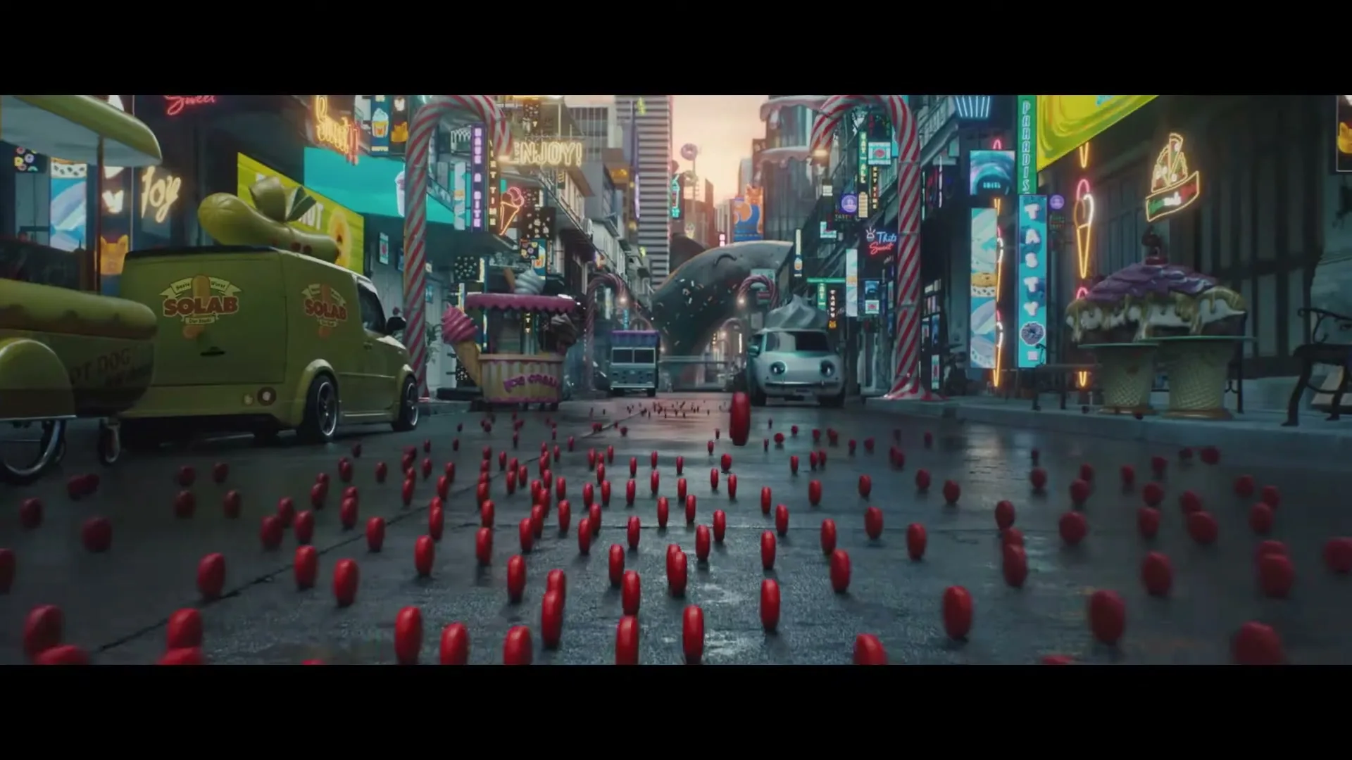 Hundreds of small red Babybel cheeses roll down a city street filled with food trucks and neon signs, creating a whimsical, urban landscape.