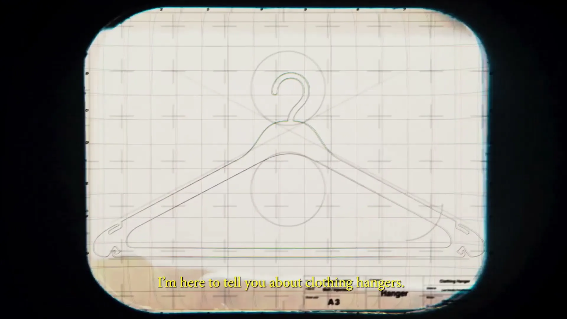 A blueprint of a clothing hanger is shown on a gridded background, with text appearing at the bottom of the screen.