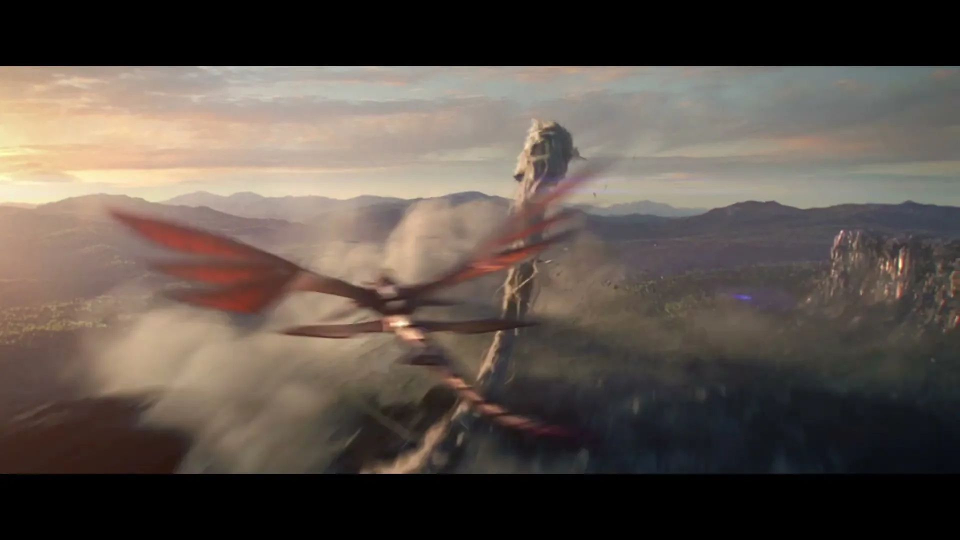 A large, white, serpentine dragon with a long tail flies through a mountainous landscape at sunset, with a smaller red dragon flying past it.