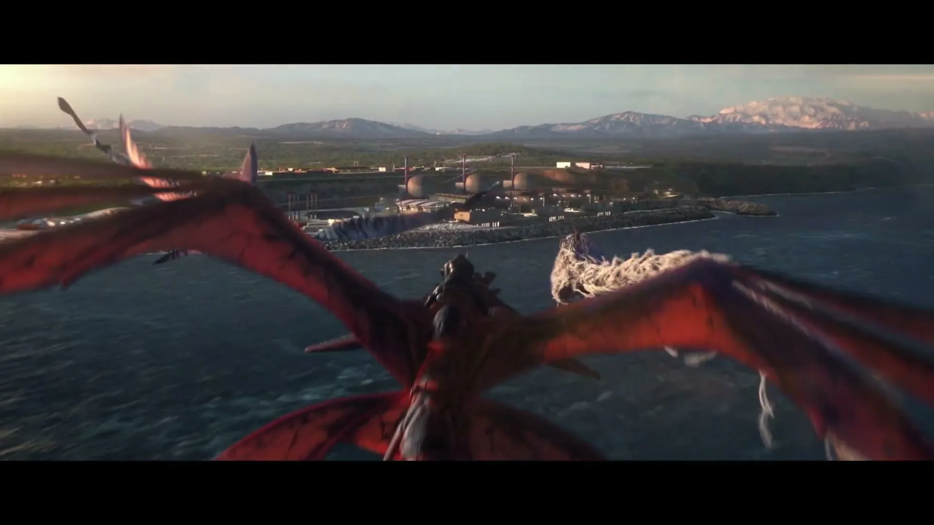 Two dragons fly over the ocean towards a power plant on the coast, with mountains in the background.