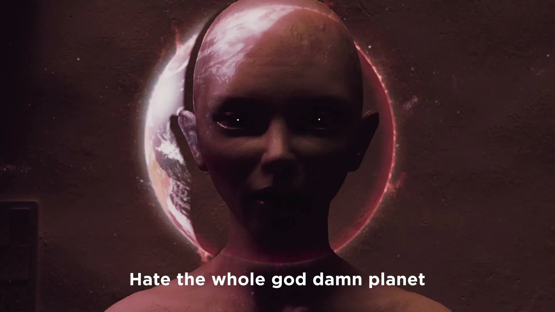 A bald, androgynous figure with glowing eyes and a planet projected onto its face, stands against a dark wall as a fiery ring appears around its head.