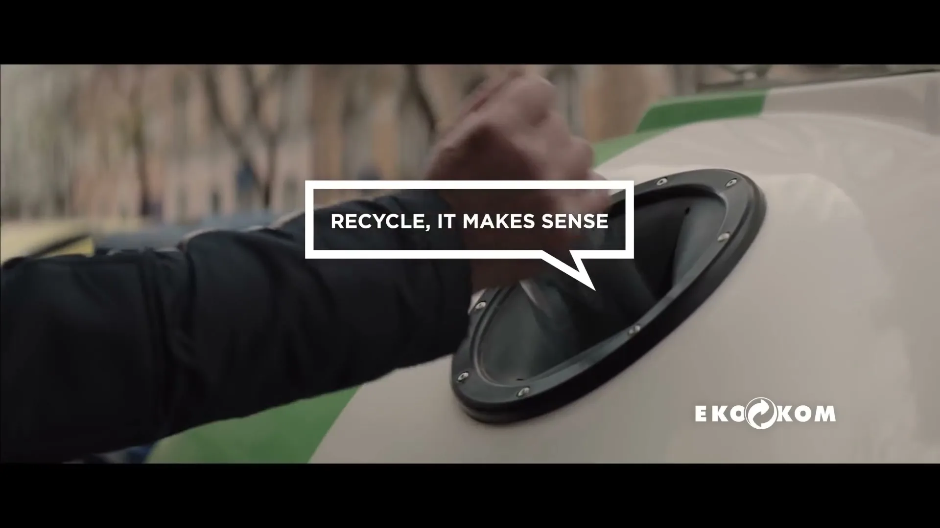A person's hand is seen placing an item into a recycling bin, with text overlayed on the screen.