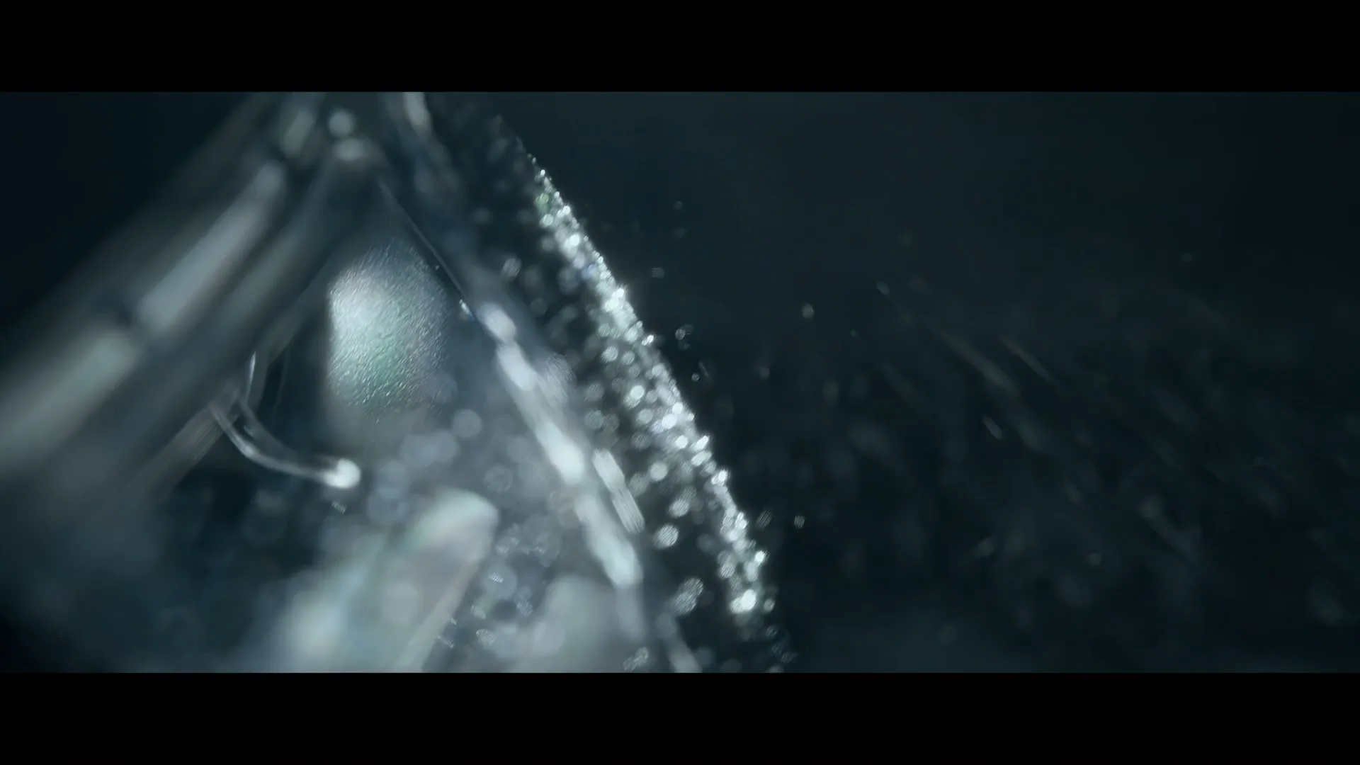 A close-up shot of a tire tread with water droplets, emphasizing the texture and wet conditions.