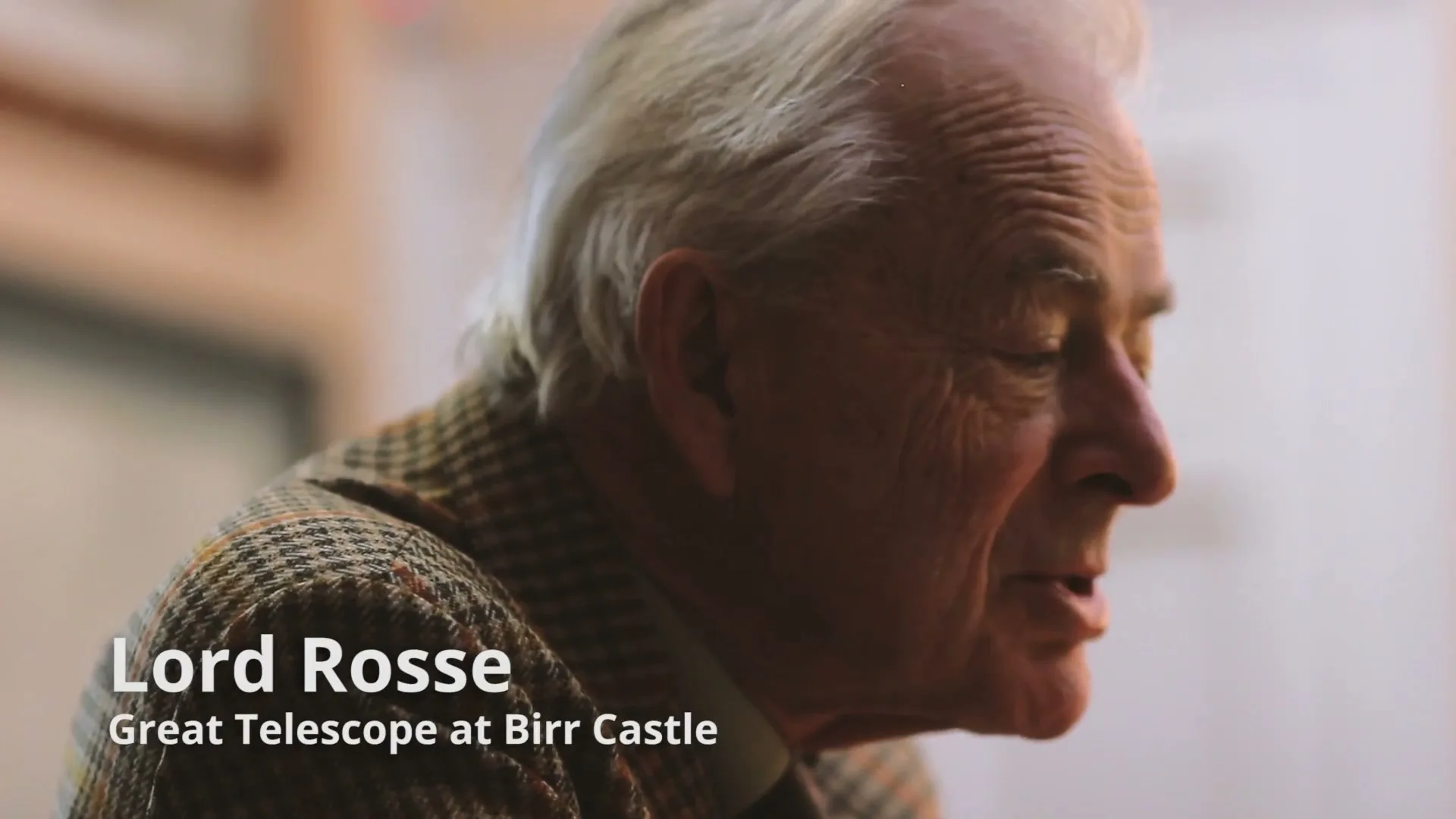 An elderly man with white hair and a tweed jacket speaks, looking off-camera, with text identifying him as Lord Rosse and his connection to the Great Telescope at Birr Castle.